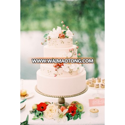 A four-tiered white wedding cake